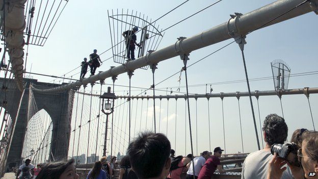 New York Police officers climb the Brooklyn Bridge.