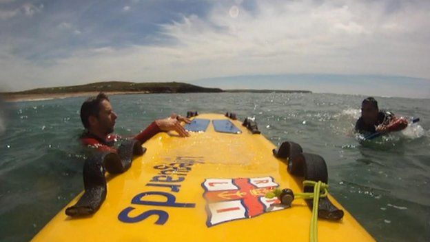 RNLI lifeguards rescue a man off Freshwater West, Pembrokeshire, in July 2014
