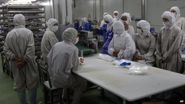 Husi Foods employees stand idle, in this picture released by Xinhua news agency