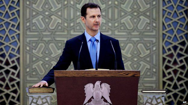 In this Wednesday July 16, 2014 photo, and released by the Syrian official news agency SANA, Syria"s President Bashar Assad is sworn for his third, seven-year term, in Damascus, Syria
