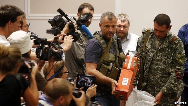 File photo: A pro-Russian separatist shows members of the media a black box belonging to Malaysia Airlines flight MH17, before its handover to Malaysian representatives, in Donetsk, 22 July 2014
