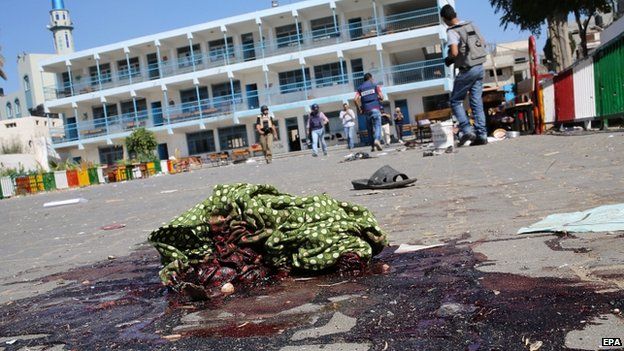 A piece of cloth lies in a pool of blood outside a UN-operated school after an Israeli attack in Beit Hanoun in northern Gaza - 24 July 2014