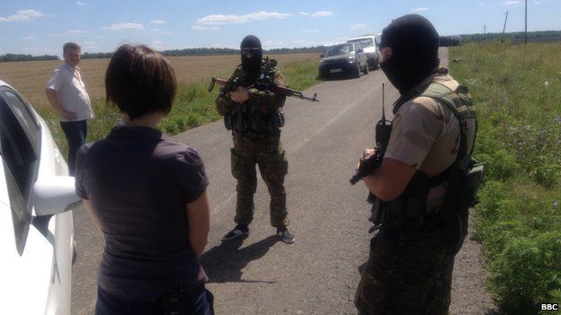 Russian separatists in Ukraine speak to the BBC's Natalia Antelava near the wreckage of the downed MH17, 24 July 2014