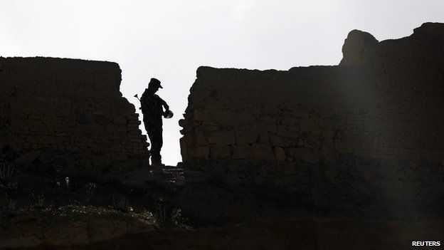 Afghan security official standing guard during the recent election campaign in Ghor