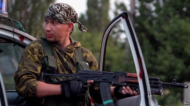 An armed separatist mans a checkpoint some 50 kilometers from the city of Donetsk