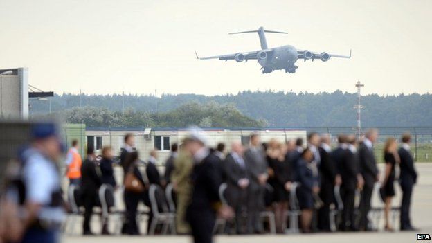 A Boeing C17 of the Royal Australian Airforce carrying 45 coffins with remains of the victims of the MH17 plane crash arrives at Eindhoven military airport, Netherlands (July 25 2014)