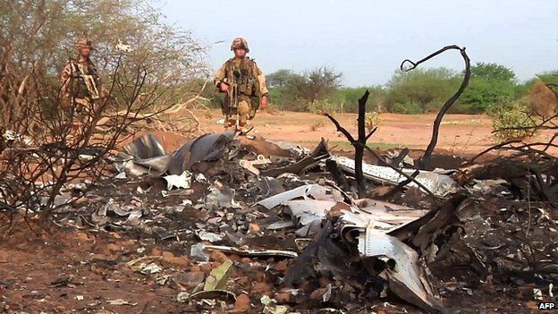 French soldiers inspect the wreckage of the Air Algerie flight AH5017 at the crash site in Mali - 25 July 2014