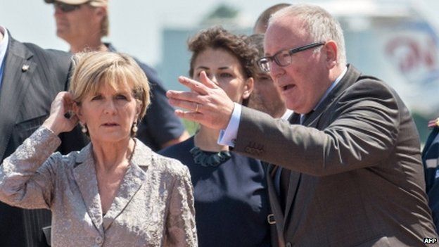 Dutch Foreign Minister Frans Timmermans (right) and his Australian counterpart Julie Bishop attend a ceremony at Kharkiv airport on Friday during which coffins containing the remains of MH17 victims were flown to Holland