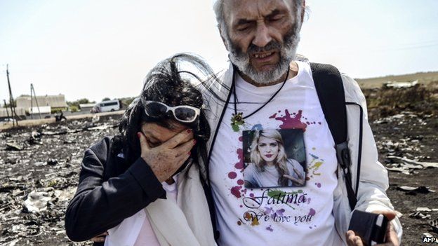 Angela Rudhart-Dyczynski and Jerzy Dyczynsk from Australia react as they arrive at the crash site to look for their late daughter Fatima