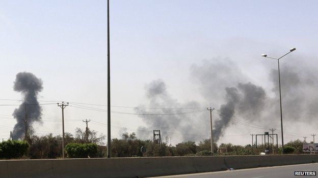 Smoke rises over the Airport Road area after heavy fighting between rival militias broke out near the airport in Tripoli on 25 July 2014.
