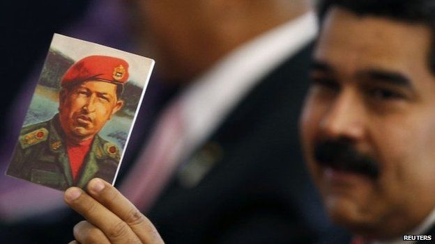 Maduro holds a picture of Chavez