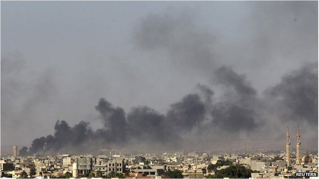 Black smoke after clashes between militants and government forces in Benghazi on 26 July.