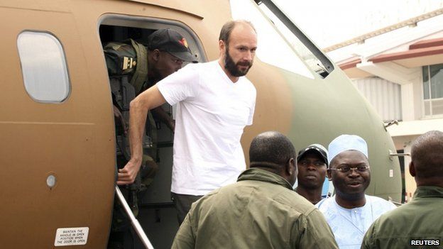 French hostage Georges Vandenbeusch, a French Catholic priest, disembarks from plane in Yaounde on 31 December 2013