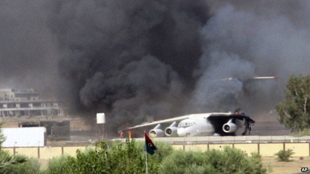 Smoke billowing from a plane at Tripoli airport