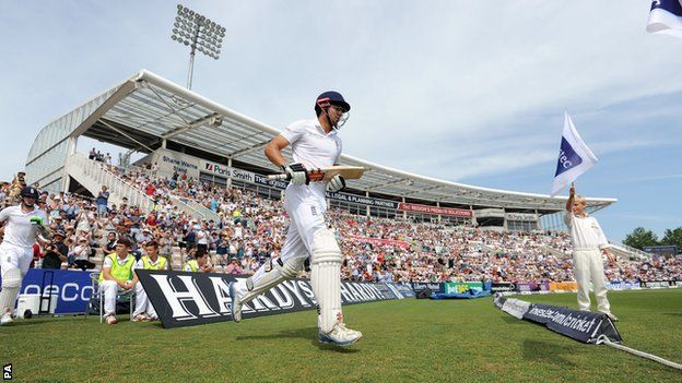 Alastair Cook walks out to bat