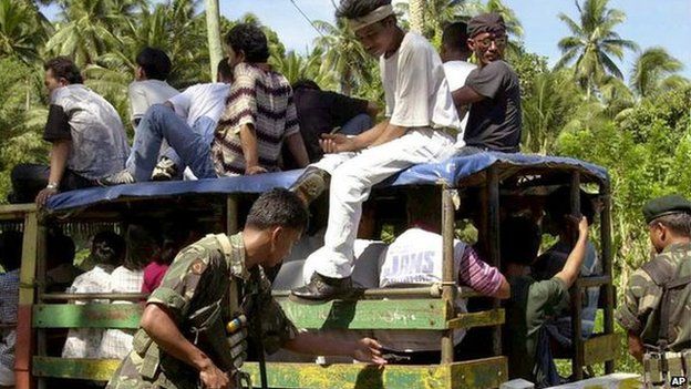 Government soldiers inspect a passenger jeepney at a military checkpoint Friday, Sept. 8, 2000 in the outskirt of Jolo in southern Phillippines.