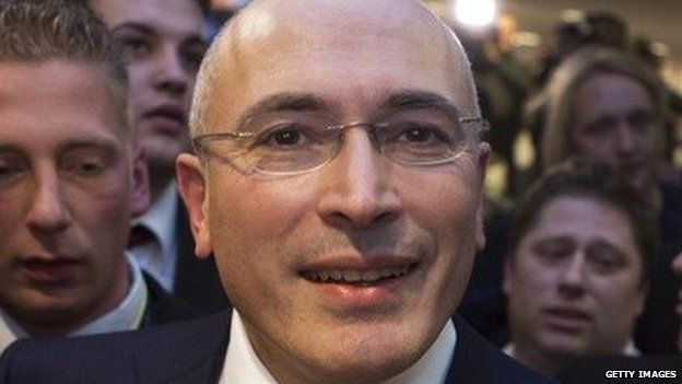 Mikhail Khodorkovsky leaves a press conference in Berlin.