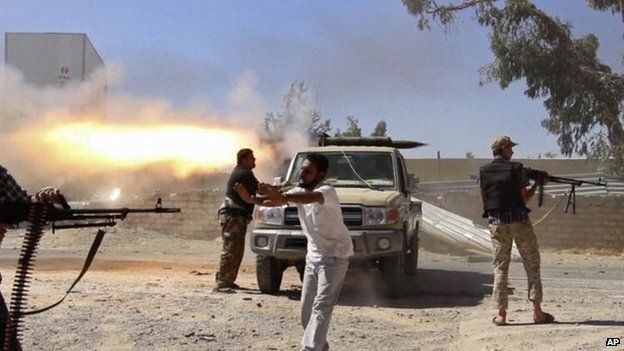 Grab from video obtained from a freelance journalist travelling with the Misarata brigade, fighters from the Islamist Misarata brigade fire towards Tripoli airport in an attempt to wrest control from a powerful rival militia, in Tripoli, Libya on 26 July 2014