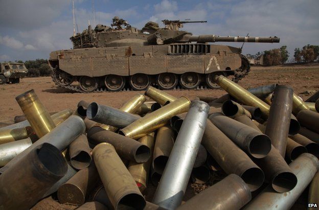 Empty shells beside an Israeli tank near the Gaza border, 28 July