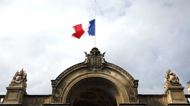 The French flag flies at half-mast above the entrance of the Elysee Palace in Paris - 28 July 2014