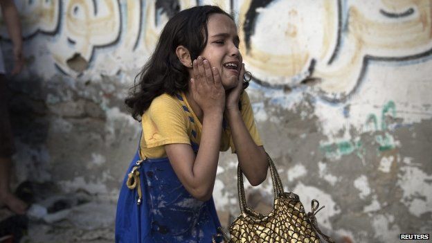A Palestinian girl at the scene of an explosion that medics said killed eight children and two adults at a public garden in Gaza City
