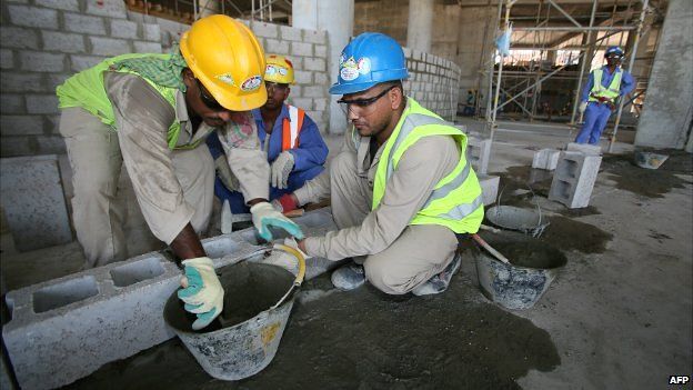 Migrant labourers work on a construction site in Doha, Qatar - 3 October 2013