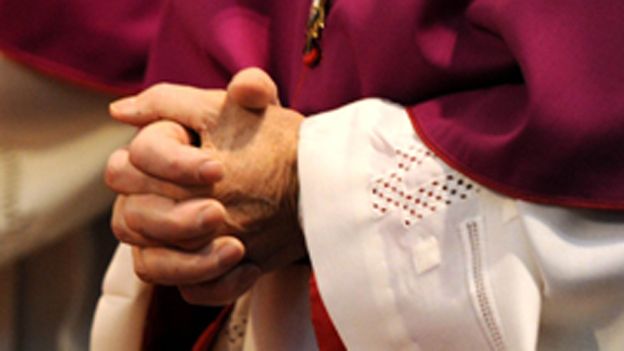 Hands of clergy in prayer
