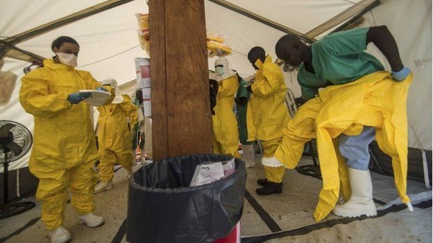 Medical staff working with Medecins sans Frontieres (MSF) put on their protective gear before entering an isolation area at the MSF Ebola treatment centre in Kailahun on 20 July 2014