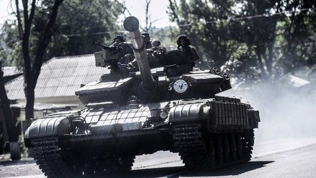 Pro-Russian militants sit on a tank in Donetsk, eastern Ukraine