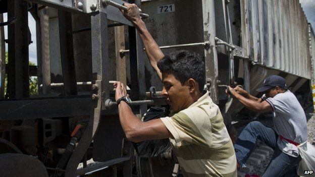 Central American migrants get on La Bestia cargo train in Apizaco on 22 July, 2014