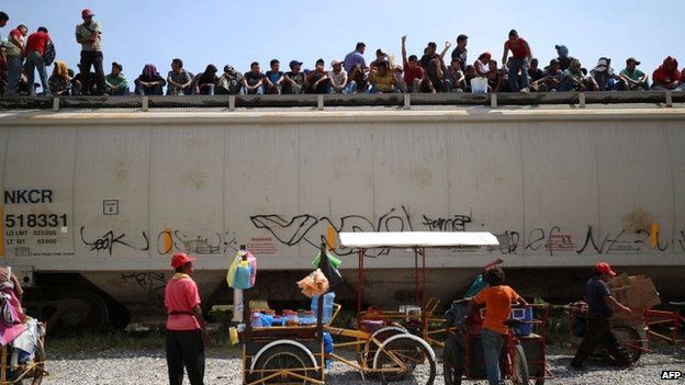 Central American immigrants sit atop La Bestia in Arriaga on 16 July, 2014