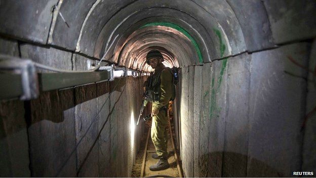 An Israeli soldier stands in a tunnel said to be captured from Hamas militants, 25 July 2014