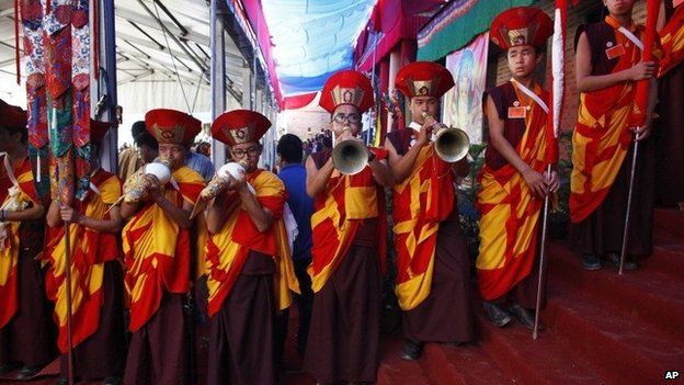 Monks play traditional instruments during the funeral of revered Tibetan Buddhist monk Shamar Rinpoche at the Shar Minub monastery near Kathmandu, Nepal, Thursday, July 31, 2014.