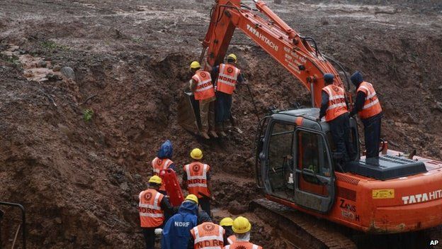 Rescuers work at the site of a massive landslide in Malin village in Pune district of western Maharashtra state, India, Thursday, July 31, 2014.
