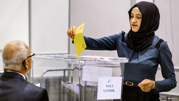 Woman casts her vote in the Turkish presidential election at a polling station in the Netherlands on 31 July 2014