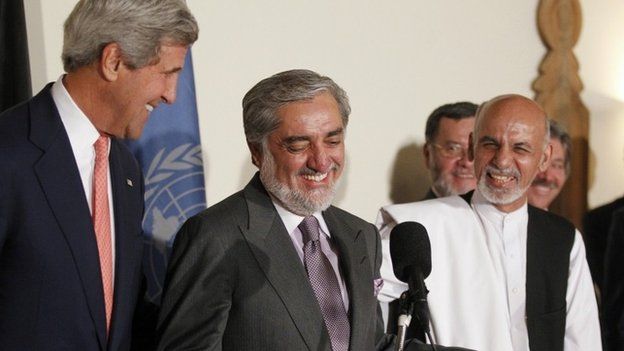 US Secretary of State John Kerry (L) and Afghan presidential candidates Abdullah Abdullah (C) and Ashraf Ghani (R) smile as they speak at a press conference announcing an audit of the votes cast in the country's general election at the United Nations Compound in Kabul on late July 12, 2014.