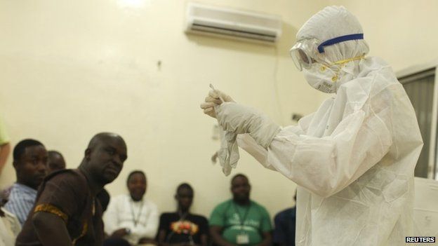 A Samaritan's Purse medical worker demonstrates personal protective equipment to educate team members on the Ebola virus in Liberia (undated photo)