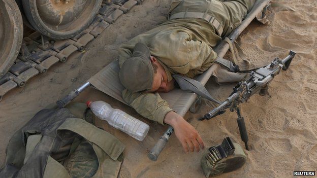 An Israeli soldier rests on a stretcher near the border with the Gaza Strip