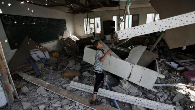 A displaced Palestinian child stands in a classroom, at the Abu Hussein UN school in Jabaliya, Gaza
