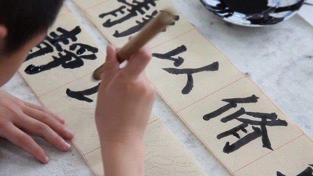 TV still of Beijing children practising Chinese calligraphy