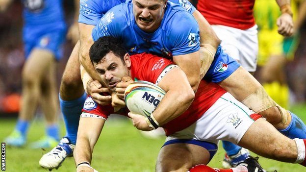 Rhys Williams is tackled by Italy's James Tedesco