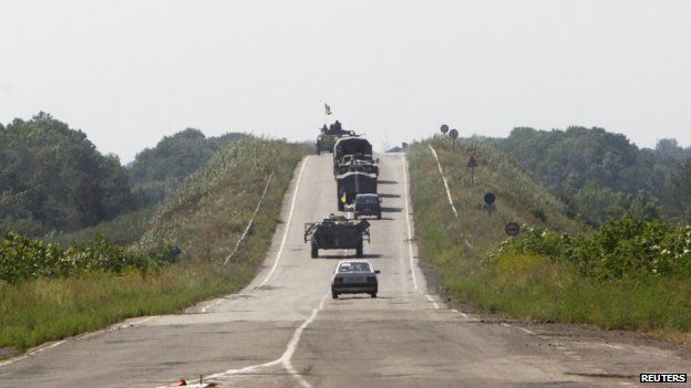 Trucks and armoured vehicles of the Ukrainian army along a road outside the eastern Ukrainian village of Nikishyne, in Donetsk region (1 August 2014)