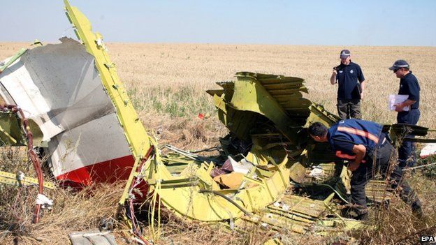 Australian and Dutch investigators examine a piece of debris from the Malaysia Airlines Flight MH17 plane, near the village of Hrabove, 100km from Donetsk, eastern Ukraine (1 August 20014)