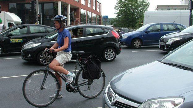 A female cyclist in traffic