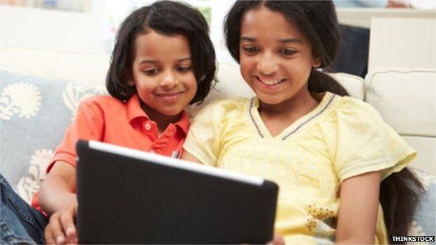 Indian girls play with a tablet