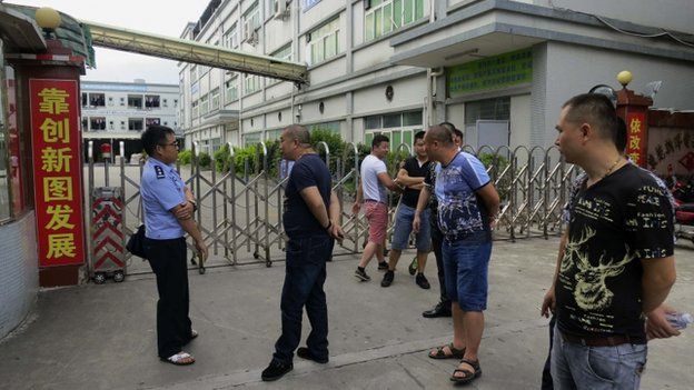 Debt collectors outside Dongguan Shinyang Electronics factory