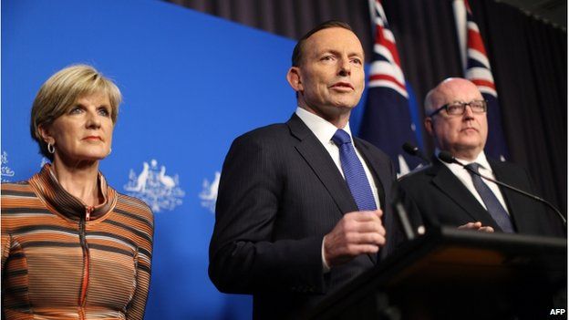 This picture released by the Australia Prime Minister Office on 5 August 2014 shows Prime Minister Tony Abbott (centre) speaking at a joint press conference with Foreign Minister Julie Bishop and Attorney General George Brandis (right) in Canberra