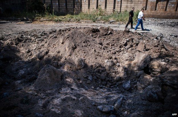 A crater left by a reported air strike on Donetsk, 6 August