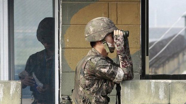 A South Korean army soldier looks through a pair of binoculars at a military check point at the Imjingak Pavilion near the border with North Korea, South Korea, Sunday, 13 July 2014.