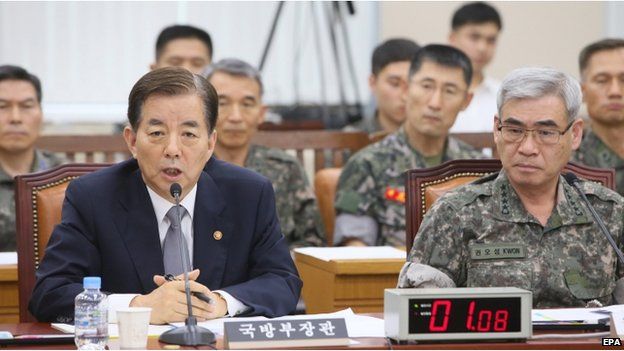 South Korean Defence Minister Han Min-koo (L) answers lawmakers' questions on the death of an Army soldier, who suffered severe abuse in his barracks, during a session of the parliamentary defence committee in Seoul, South Korea, 4 August 2014